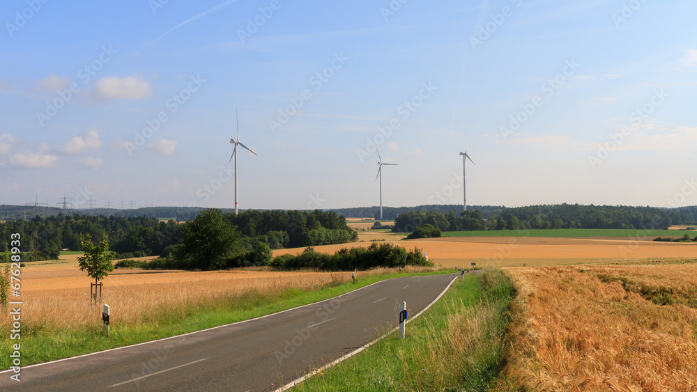 wind power plant in a field at sunraise