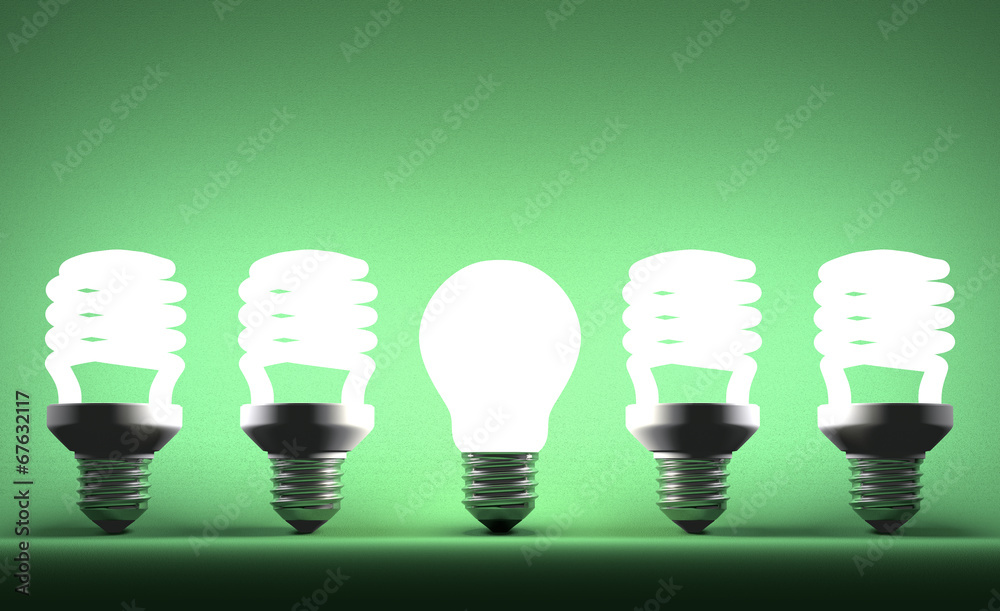 Glowing tungsten light bulb in row of spiral ones Glowing tungsten light bulb in row of spiral ones