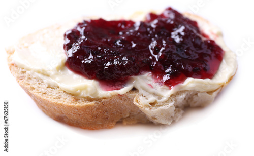 Fresh bread with blackcurrant jam and homemade butter, isolated
