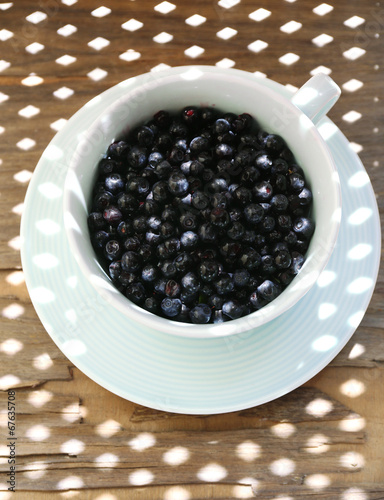 Useful blueberry in bowl on table, close-up