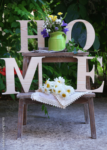 Garden decoration with wildflowers and decorative letters,