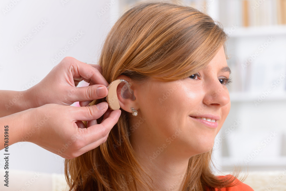 Woman wearing deaf aid Woman wearing deaf aid