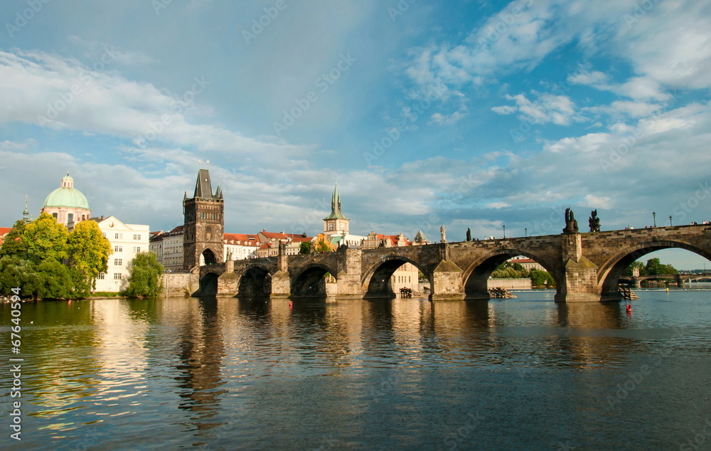 Fototapeta premium Old bridge across the wide river. Prague