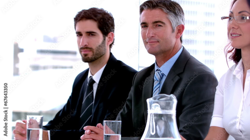 Business people sitting on interview panel Business people sitting on interview panel