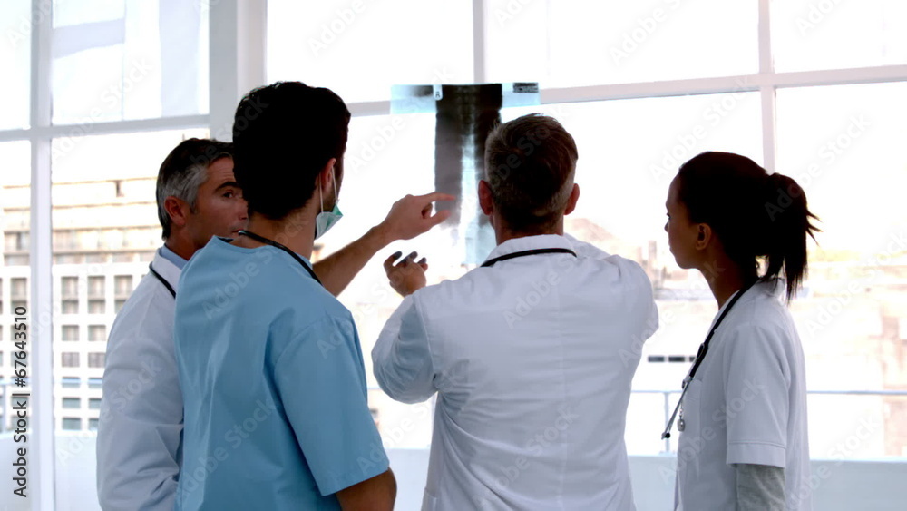 Team of doctors analysing an xray together Team of doctors analysing an xray together
