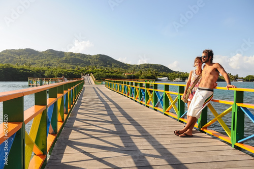 Couple looking towards the ocean, over the Love Bridge at Provid photo