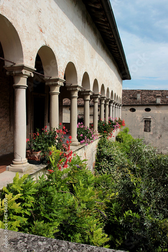 Colonnade in the cloister of an ancient abbey in Italy photo