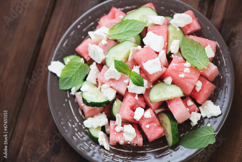 Plate with watermelon, cucumber and cheese salad, above view