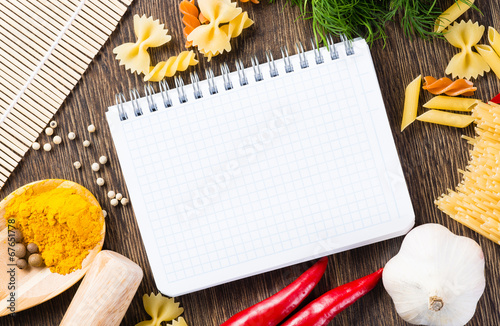 spices and vegetables around notebook