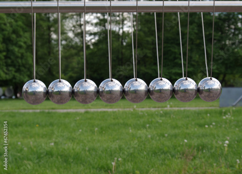 Newton balls in park, grass