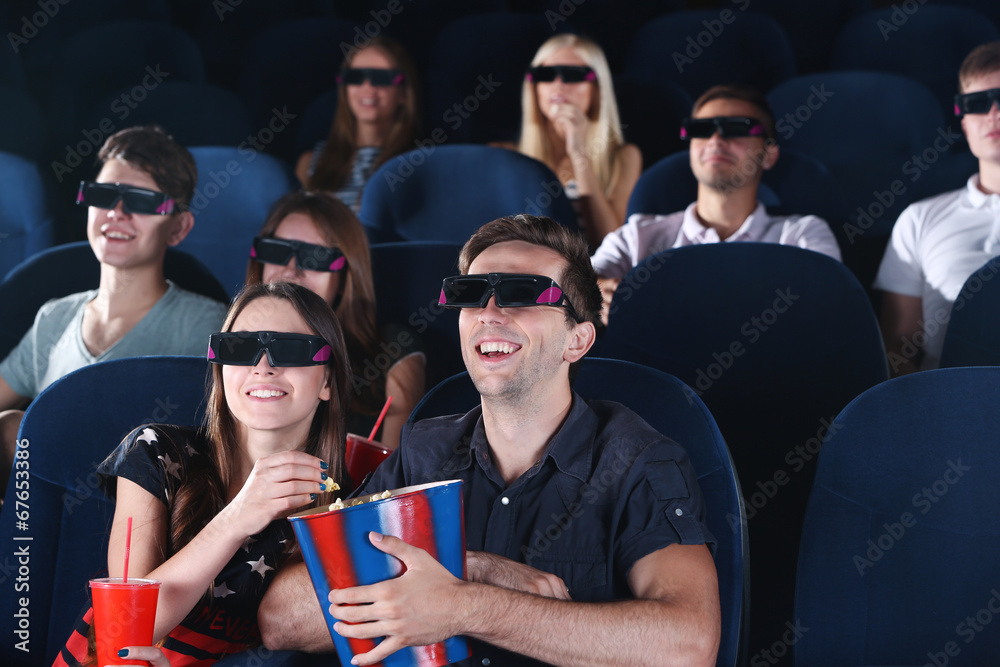 Obraz premium Young people watching movie in cinema