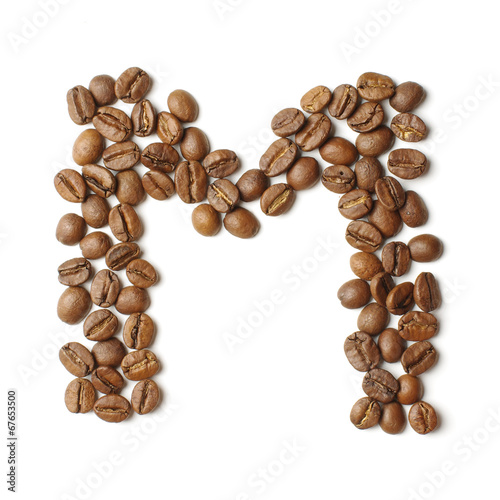 Letter M arranged from coffee beans isolated