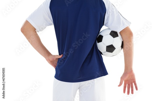 Football player in blue jersey holding ball © WavebreakMediaMicro