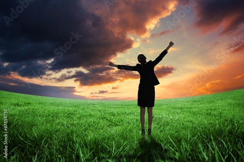 Composite image of excited businesswoman cheering