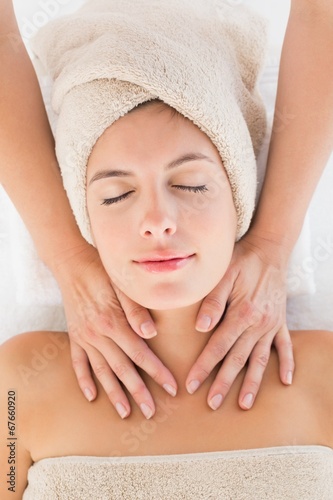 Attractive young woman receiving massage at spa center