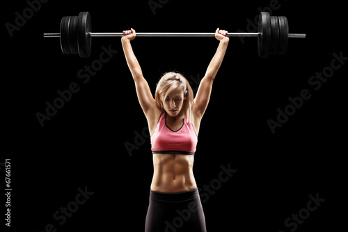 Muscular woman lifting a he...