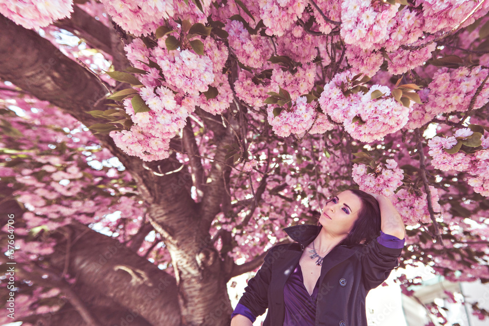 Wonderful harmony between pretty woman and blooming tree Wonderful harmony between pretty woman and blooming tree