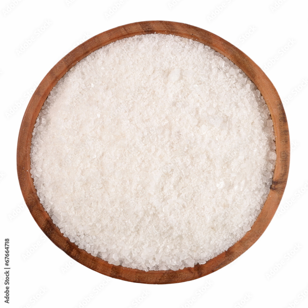 Salt in a wooden bowl on a white Salt in a wooden bowl on a white
