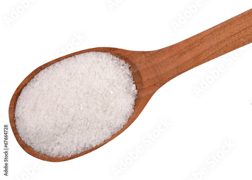 Top view of salt in a wooden spoon on a white