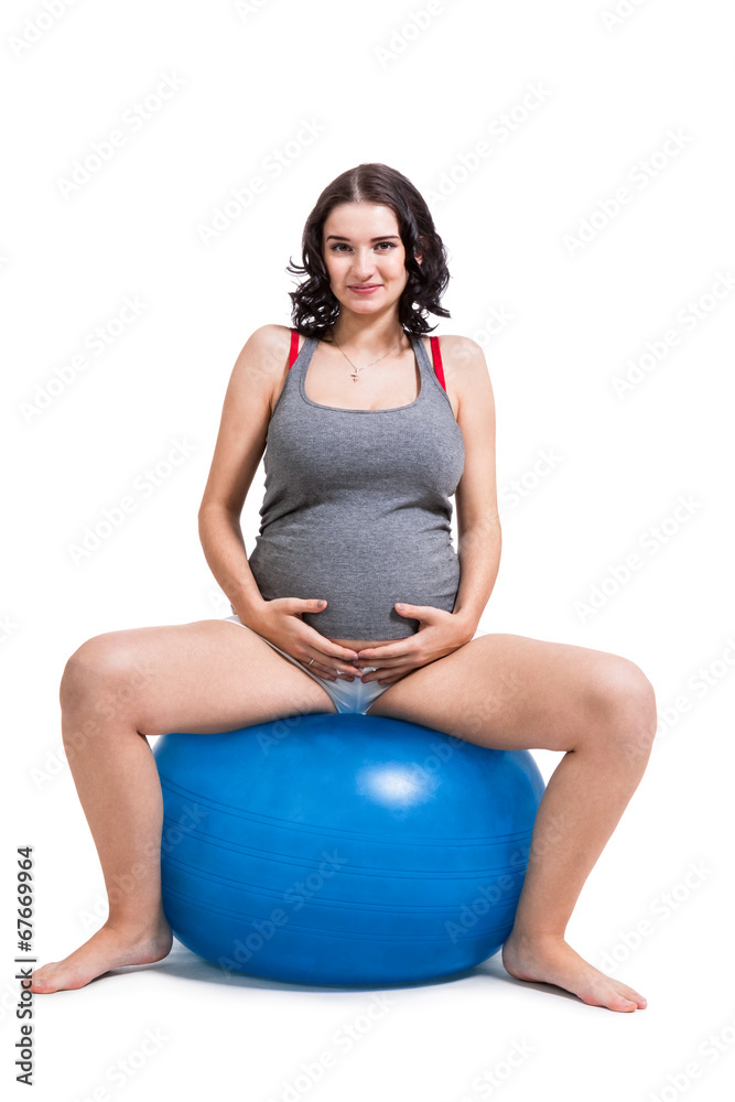 Pregnant woman doing pilates exercises Pregnant woman doing pilates exercises