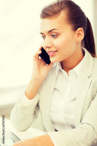 businesswoman with smartphone in office
