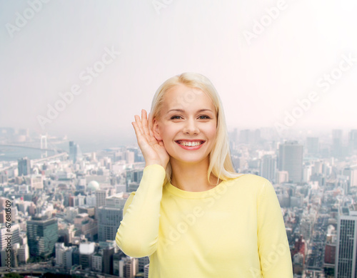 smiling young woman listening to gossip photo