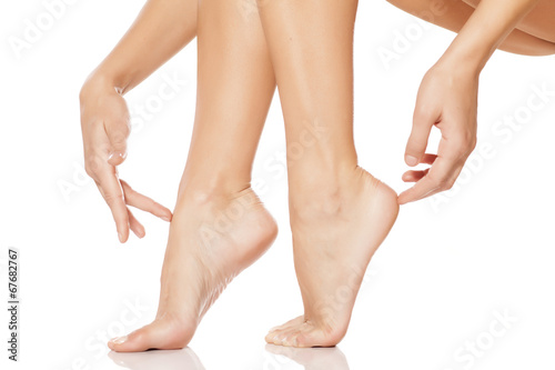 woman tenderly touching her feet