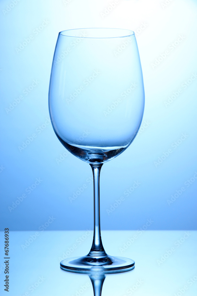 Empty wine glasses arranged on blue background Empty wine glasses arranged on blue background