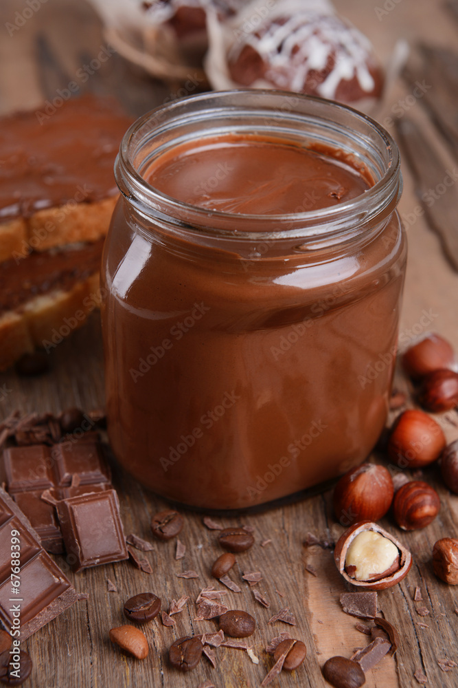 Sweet chocolate cream in jar on table close-up Sweet chocolate cream in jar on table close-up