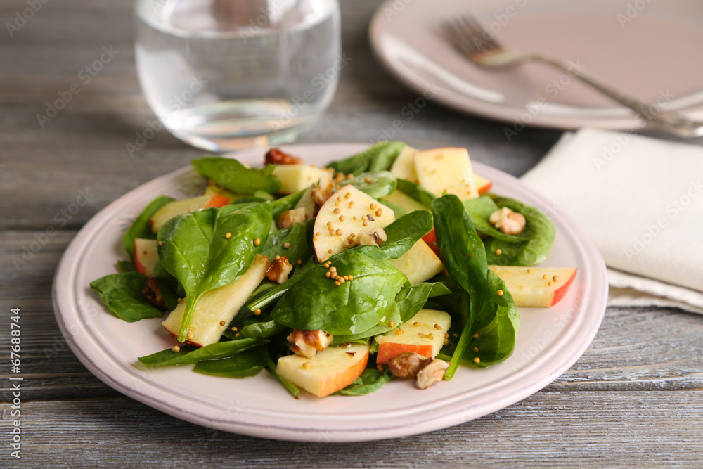 Green salad with apples, walnuts and cheese on wooden Green salad with apples, walnuts and cheese on wooden