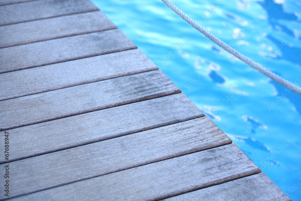 Fototapeta premium Wooden bridge on way to harbor, close-up