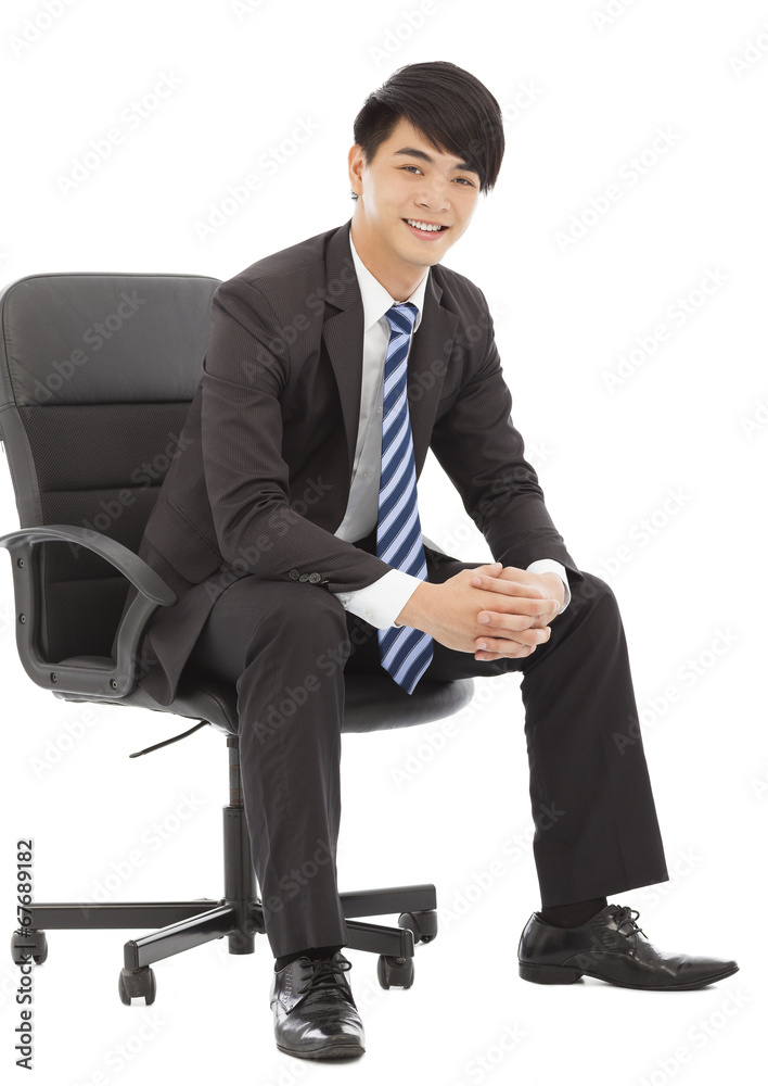 smiling and handsome Young business man sitting on a chair smiling and handsome Young business man sitting on a chair