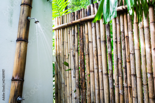 Tropical outdoor shower surrounded with bamboo walls