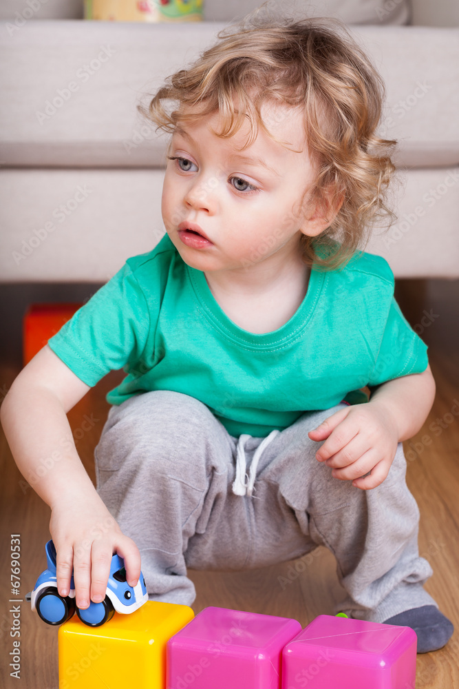 Little child playing with colorful toys Little child playing with colorful toys