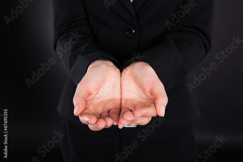 Midsection Of Businesswoman With Cupped Hands