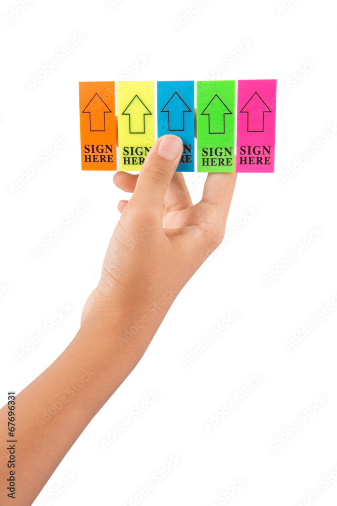 Female teenager hand holding stick it SIGN HERE arrow tag Female teenager hand holding stick it SIGN HERE arrow tag