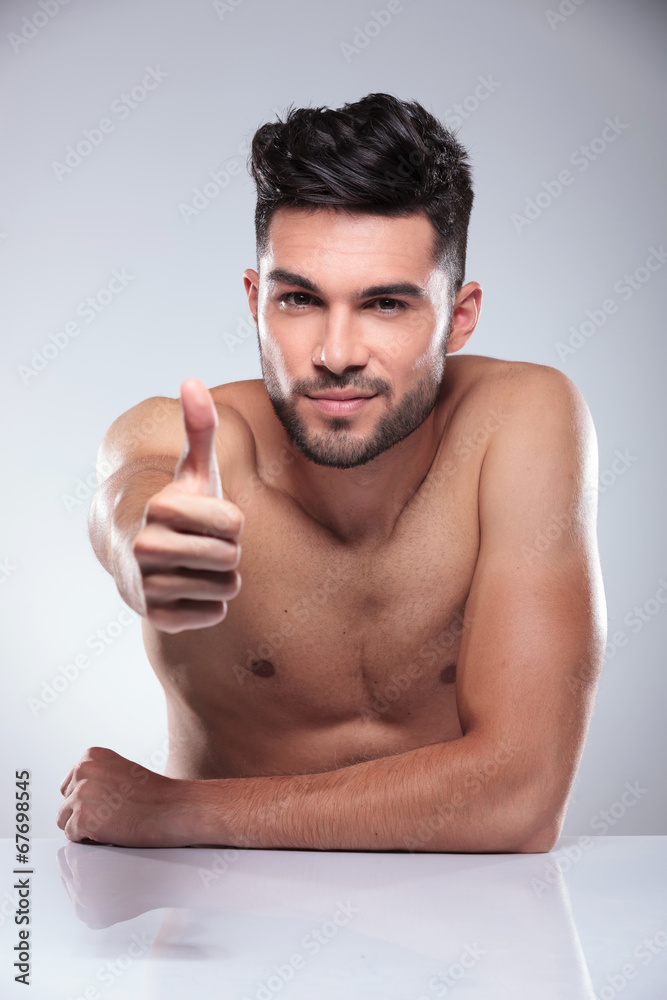 Fototapeta premium man sitting and making the ok sign