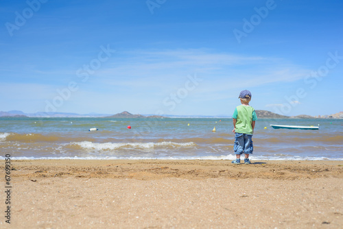 Little boy standing on the beach