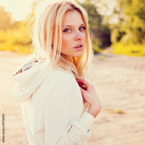 Beautiful girl outdoor in the park looking at you photo