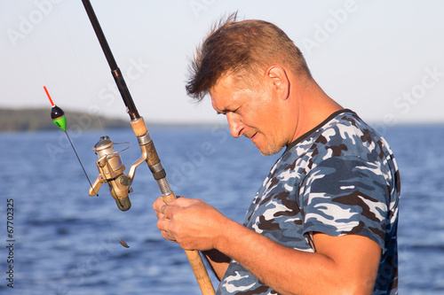 Fisherman on the lake closeup