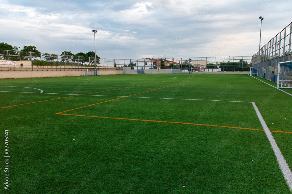 Naklejka premium football amateur stadium with green grass