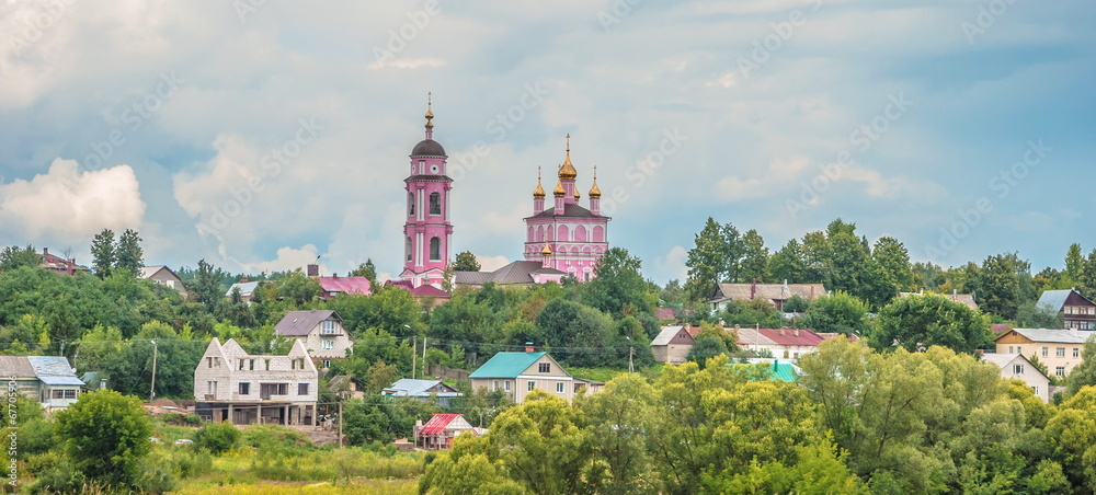Russian rural landscape with a church and meadow