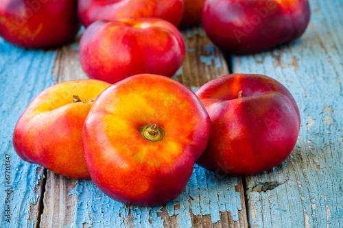 fresh organic flat nectarines on an old wooden background