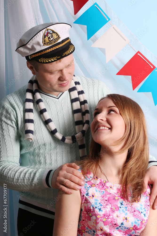 Beautiful smiling woman and man look at each other in studio Beautiful smiling woman and man look at each other in studio