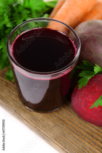 Glass of fresh beet juice and vegetables