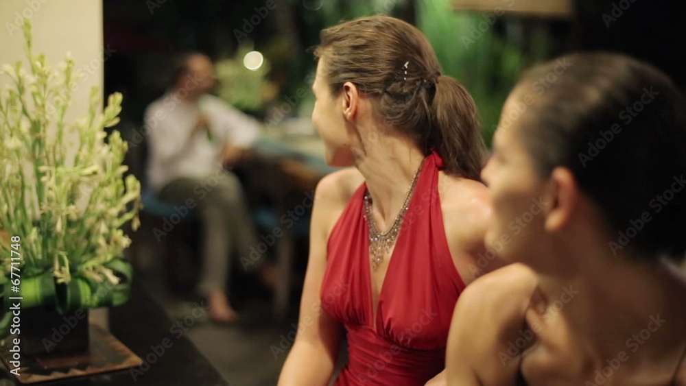 Women gossip and looking on handsome man at the party Women gossip and looking on handsome man at the party
