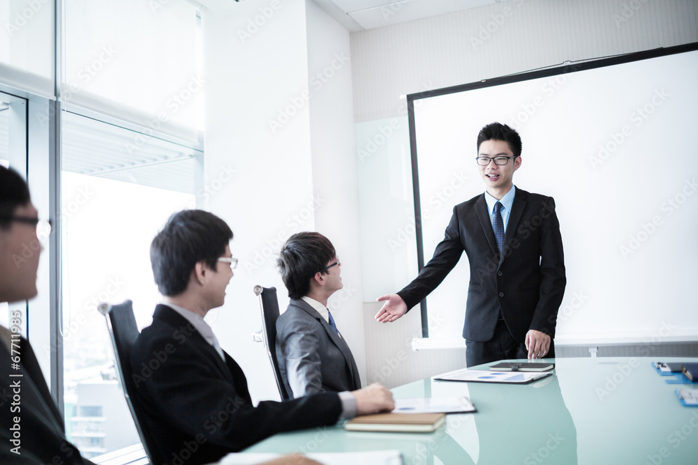 businessman giving a presentation to his colleagues businessman giving a presentation to his colleagues