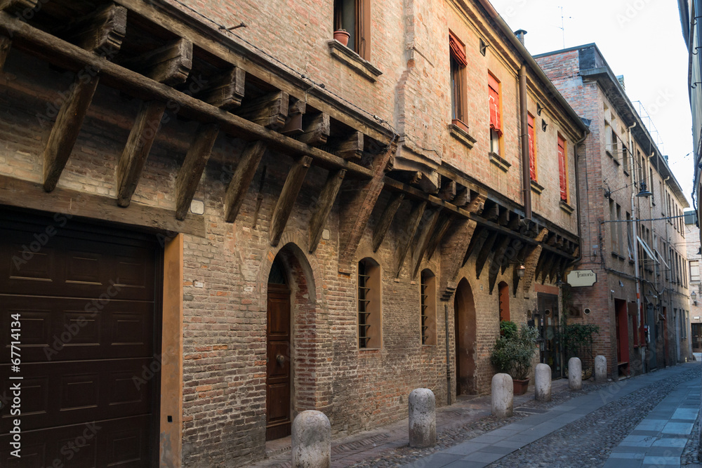 Medieval street in Ferrara with a Trattoria