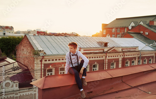 Happy hipster girl on the edge of the roof
