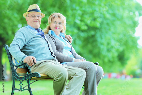 Mature couple posing in park seated on bench © Ljupco Smokovski